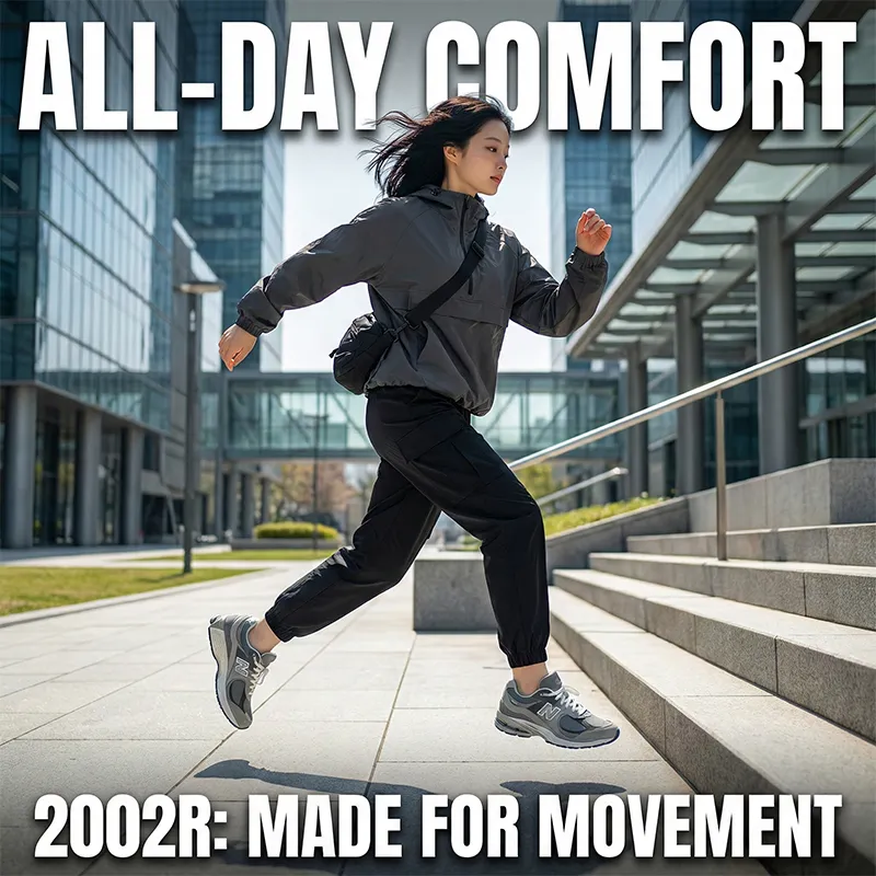 뉴발란스 2002R을 신고 도심 계단을 역동적으로 뛰어오르는 모델의 전신 사진입니다. 활동성을 강조하는 영문 텍스트가 상하단에 있습니다.